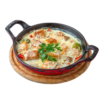 Baked in a pan salmon fillet with vegetables, cream and coconut milk